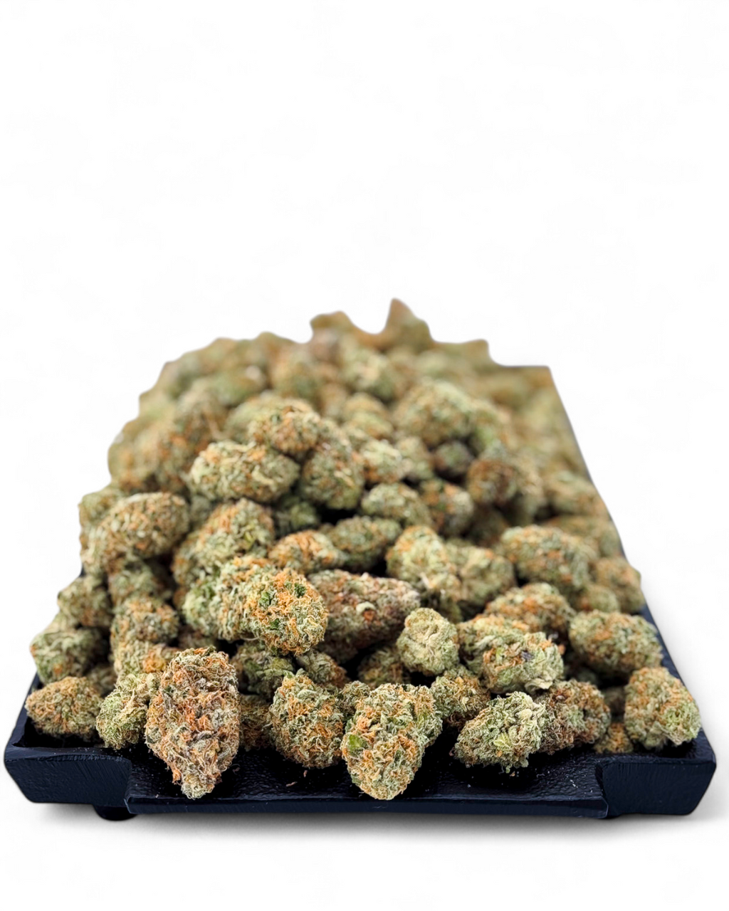 Cones of cannabis on a black tray with a white background
