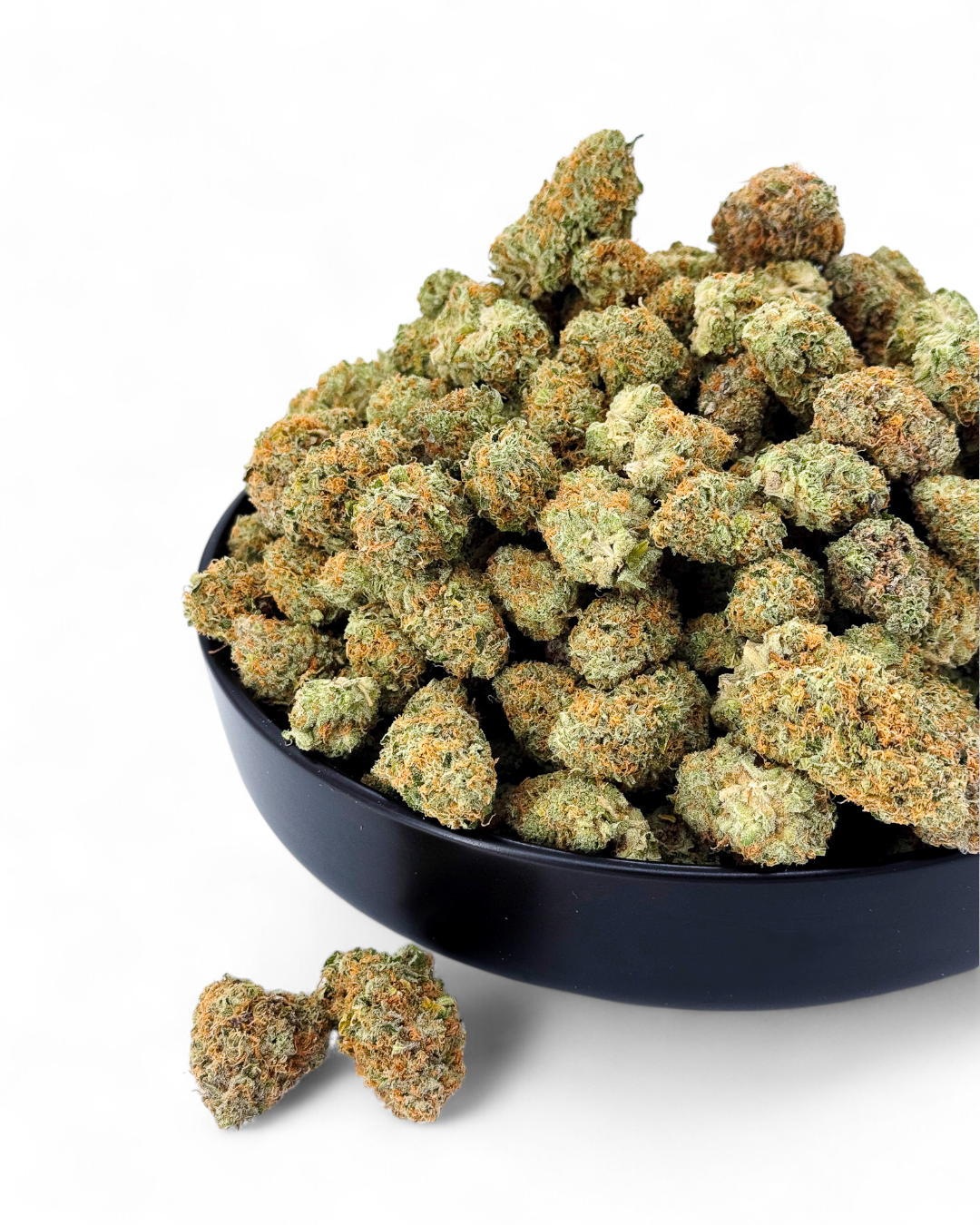 Bowl of cannabis buds on a white background