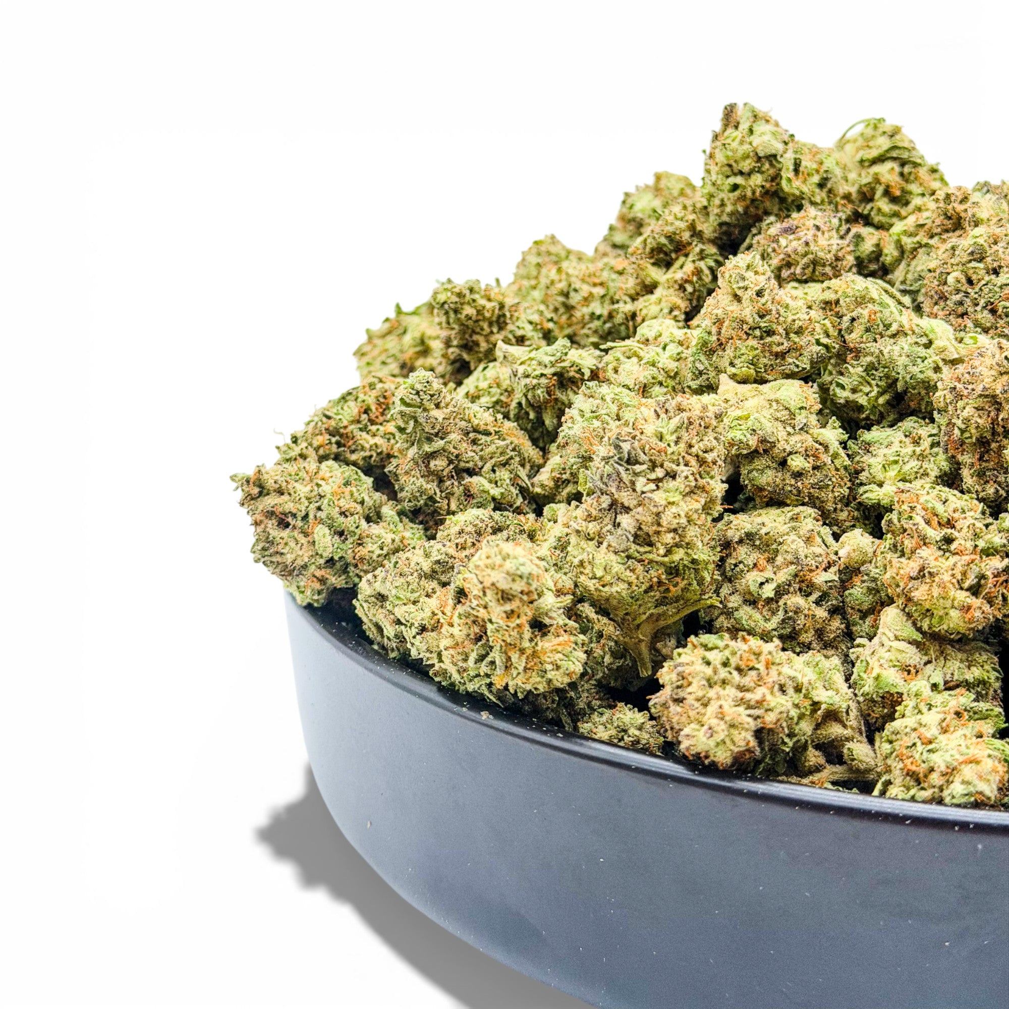 Bowl filled with green cannabis buds on a white background showing wholesale THCa flower from Dr. Wonderstone