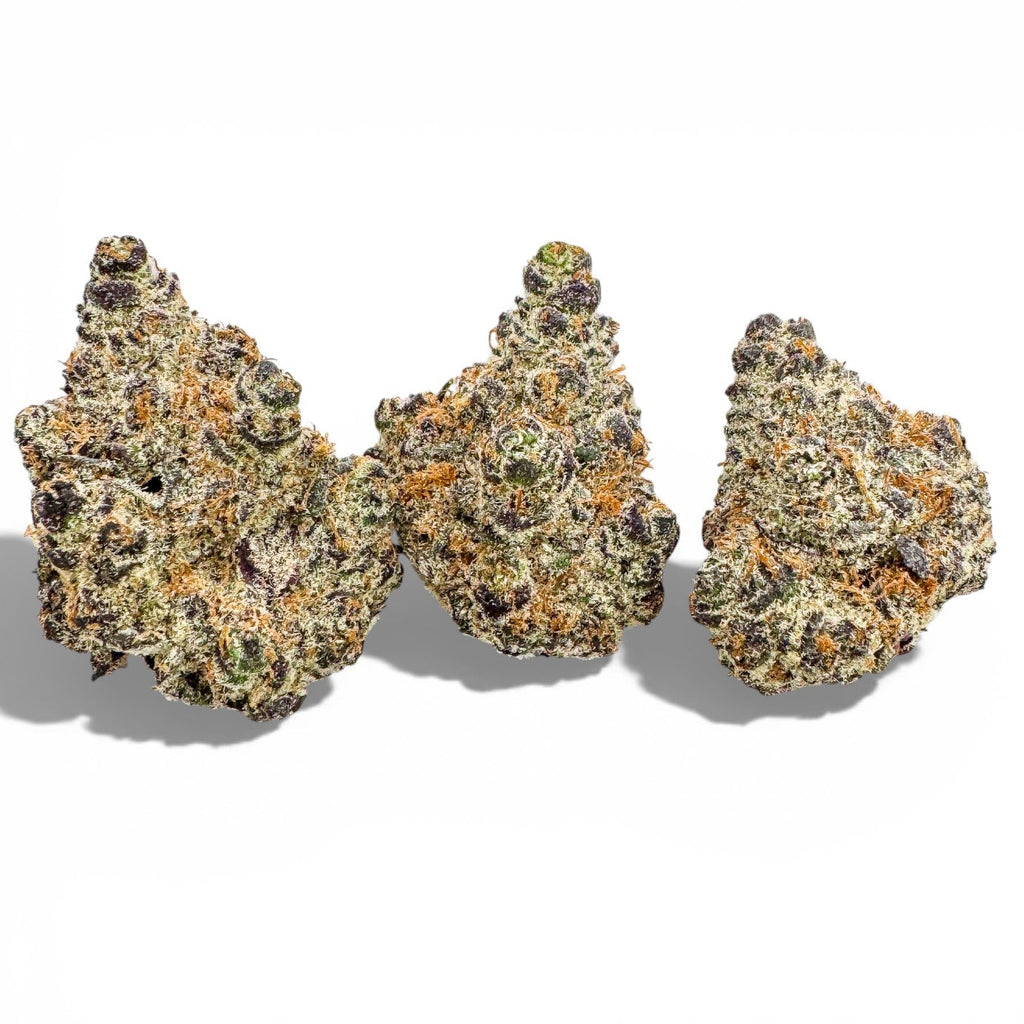 Three clumps of cannabis on a white background