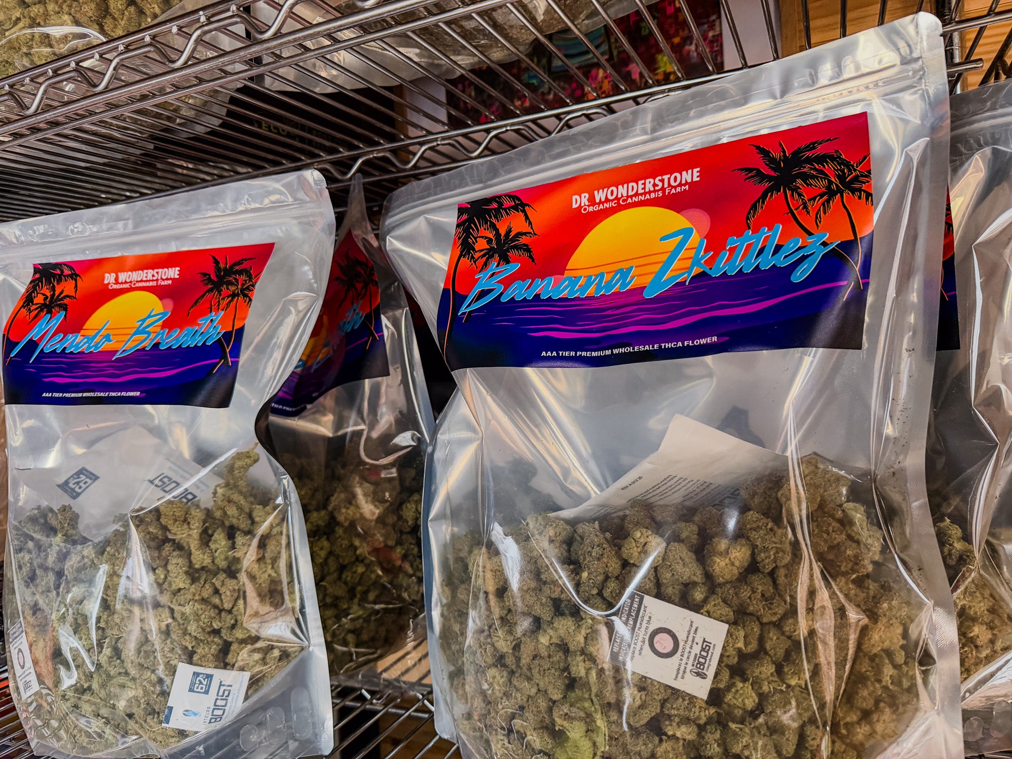 Plastic bags of cannabis with 'Dr. Wonderstone' branding on a metal shelf - wholesale THCa flower Farm Bill Compliant for store retailers