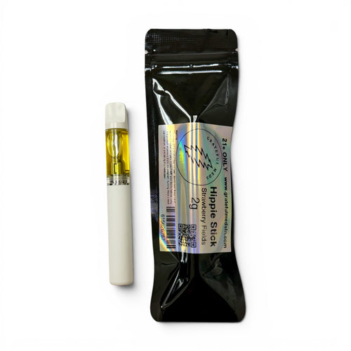 A single vape drip tip with a white body and clear chamber showing yellow oil, placed next to its black resealable pouch packaging on a white background.