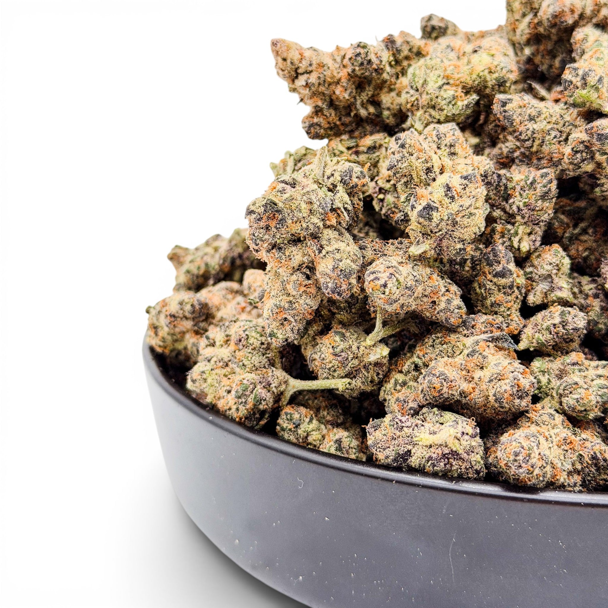 Dr. Wonderstone Premium THCa Flower buds in a dark bowl, featuring green, purple, and orange hues.