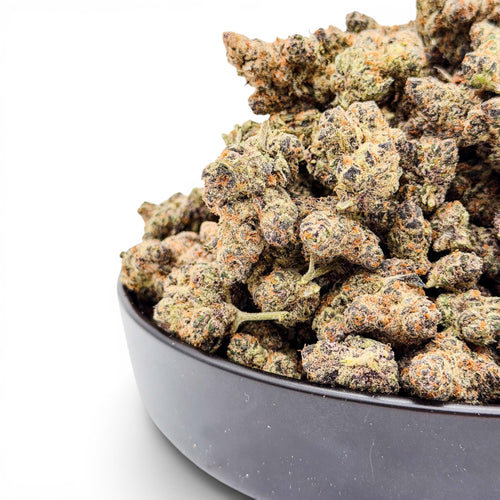 Dr. Wonderstone Premium THCa Flower buds in a dark bowl, featuring green, purple, and orange hues.