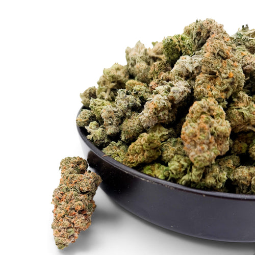 Dr. Wonderstone Alien Wedding THCa flower buds in a black bowl, featuring dense green nugs with orange pistils.