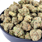 Dr. Wonderstone Banana Zkittlez THCa flower buds with dense green structure, orange pistils, and heavy trichome frosting.