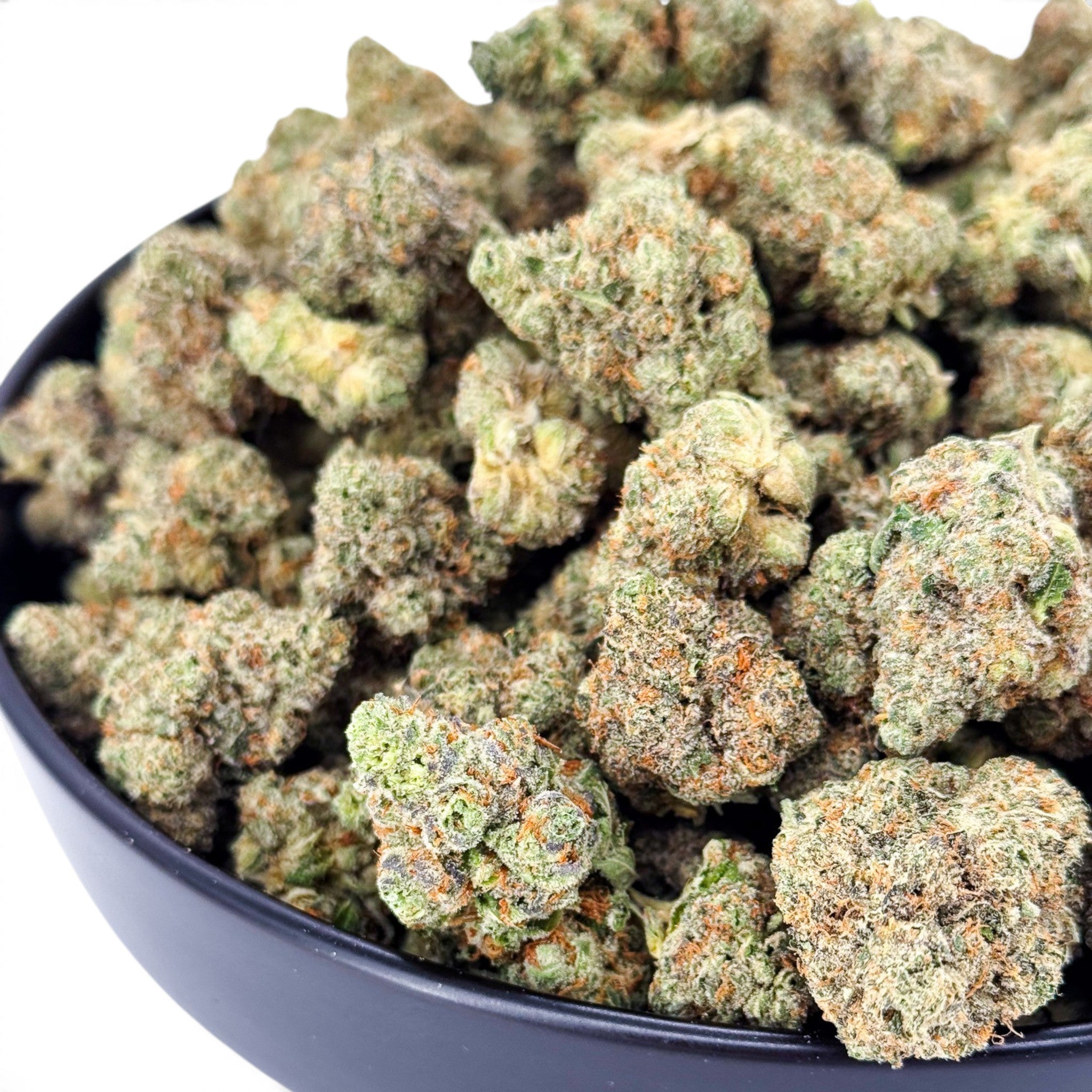 Dr. Wonderstone Banana Zkittlez THCa flower buds with dense green structure, orange pistils, and heavy trichome frosting.