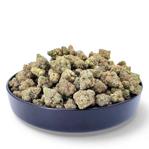 Dr. Wonderstone Banana Zkittlez THCa flower buds in a black bowl, featuring dense green nugs with frosted trichomes.