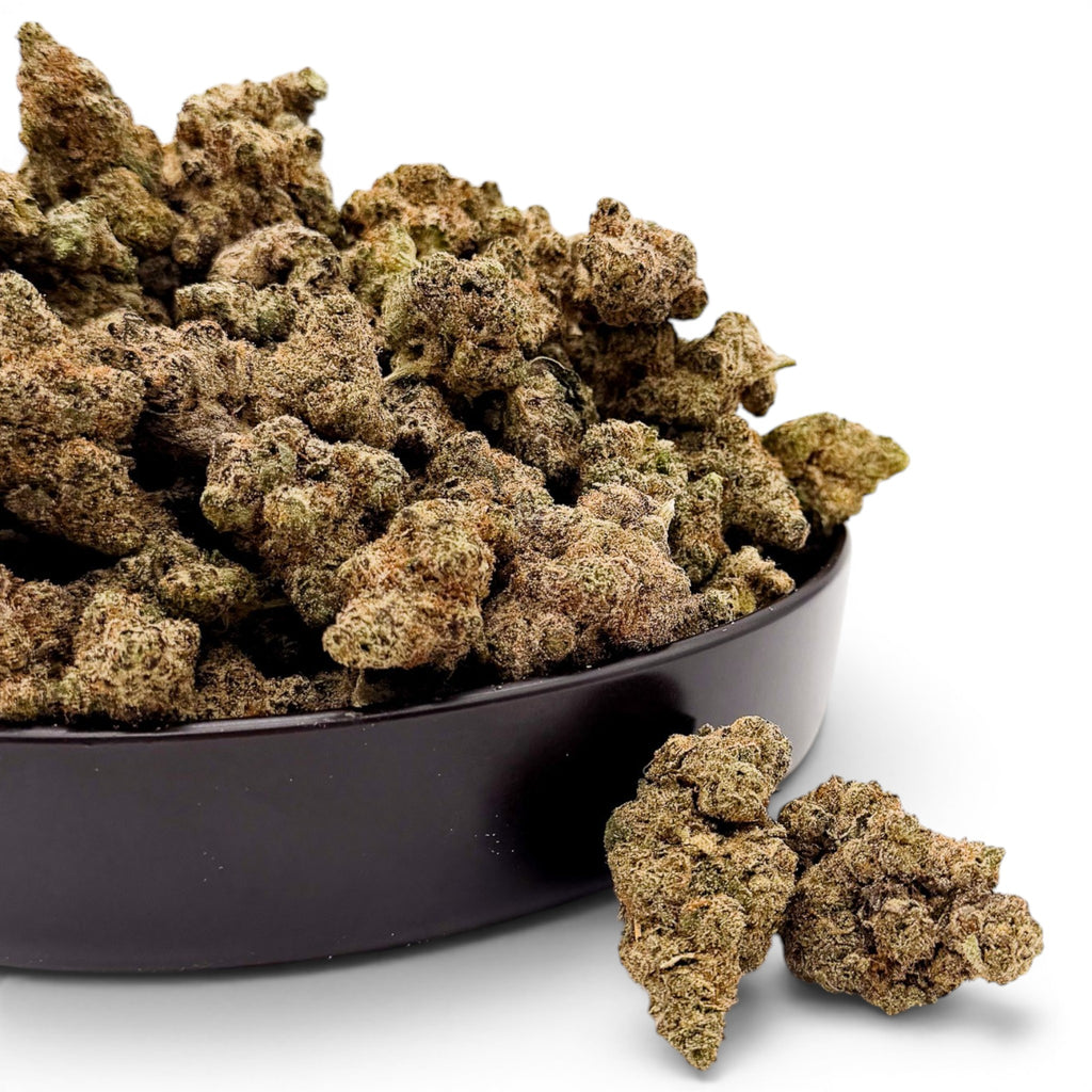 Dr. Wonderstone Blueberry Muffin THCa flower buds in a black bowl, featuring dense, sugar-coated green indica nugs.