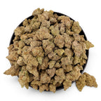 Dr. Wonderstone Blueberry Muffin THCa flower buds, featuring dense, sugar-coated green nugs in a black bowl.