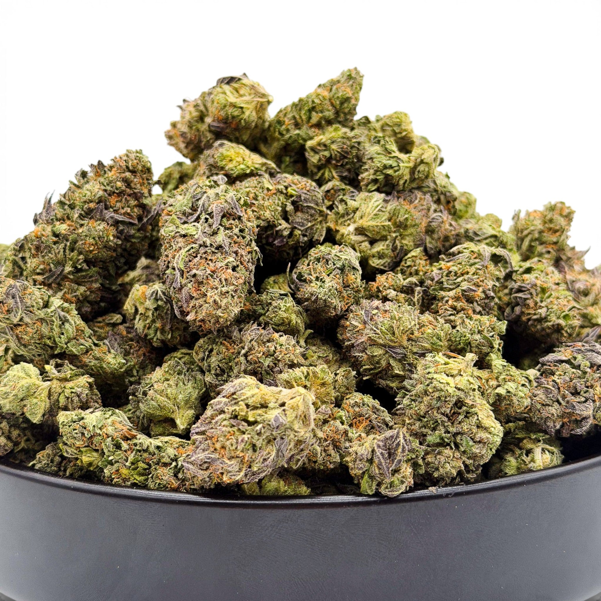 Dr. Wonderstone Cosmic Runtz indoor THCa flower buds with green and purple hues in a black bowl. Buy bulk Cannabis Flower for your retail store.