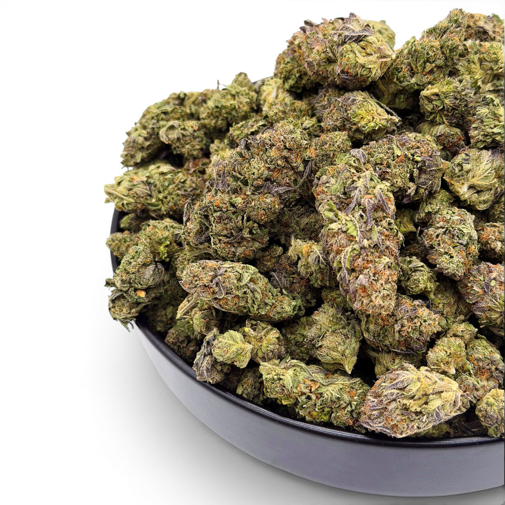 Dr. Wonderstone Cosmic Runtz Wholesale THCa flower buds with green and purple hues and orange pistils in a black bowl. Buy bulk Cannabis Flower for your retail store.