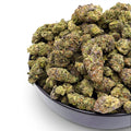 Dr. Wonderstone Cosmic Runtz Wholesale THCa flower buds with green and purple hues and orange pistils in a black bowl. Buy bulk Cannabis Flower for your retail store.