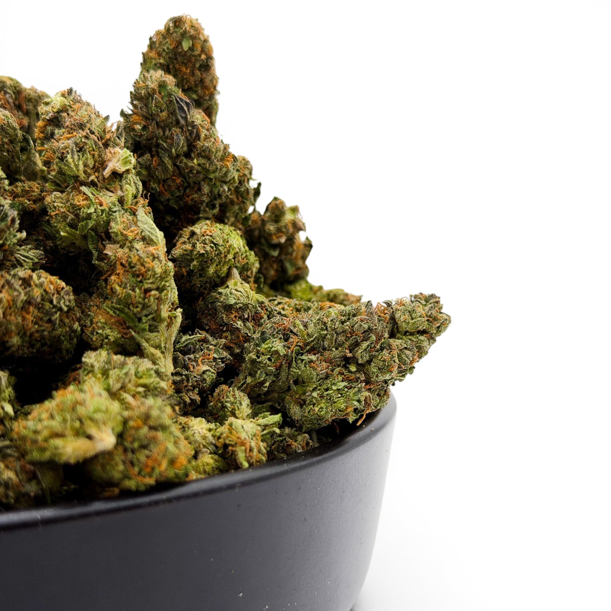 Dr. Wonderstone Dante's Inferno premium THCa flower buds with green leaves and orange pistils in a black bowl.