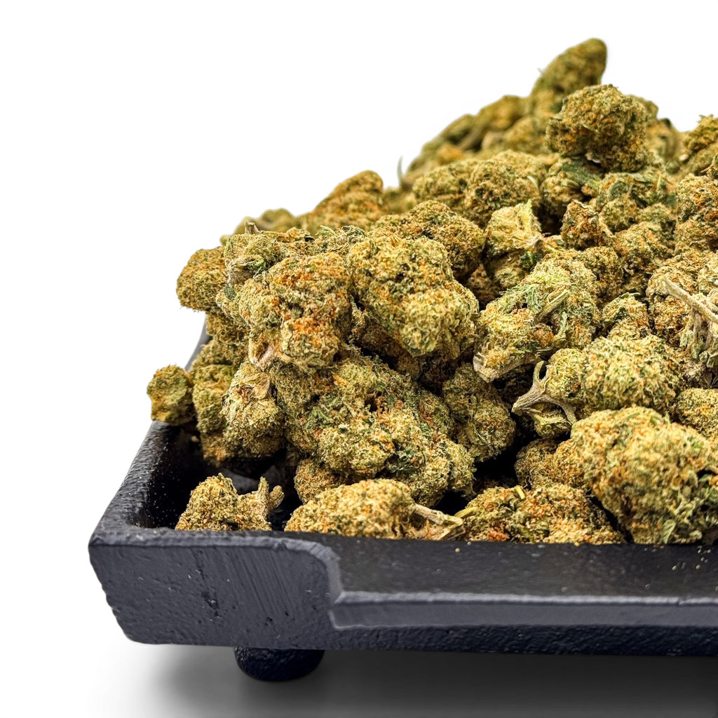 Dr. Wonderstone Green Crack THCa flower buds with vibrant green and orange hues on a black tray
