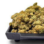 Dr. Wonderstone Green Crack THCa flower buds with vibrant green and orange hues on a black tray