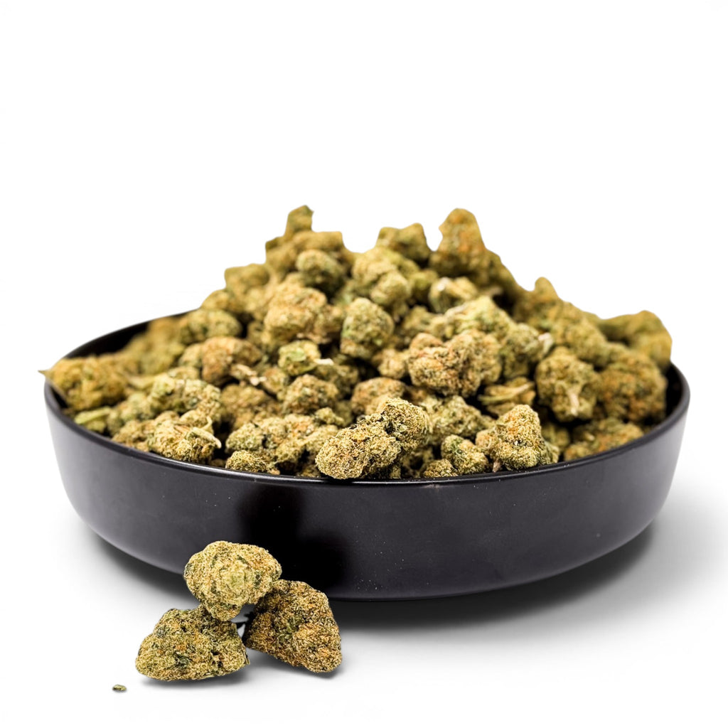 Dr. Wonderstone Green Crack THCa flower buds in a black bowl, featuring dense, light green nugs with citrus notes.