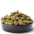 Dr. Wonderstone Ice Cream Pie THCa flower buds with dense structure and trichome coverage in a black bowl.