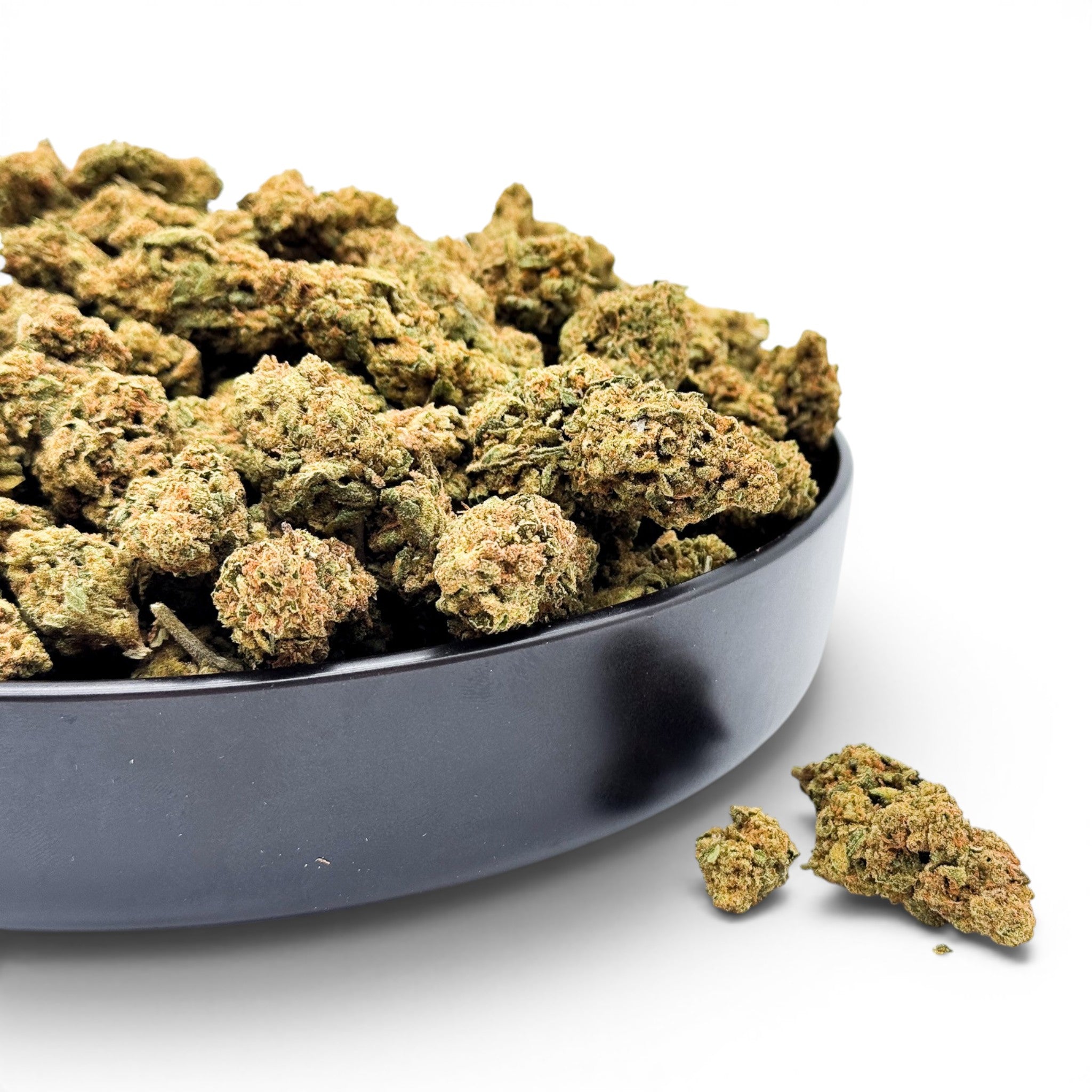 Dr. Wonderstone Jack Herer THCa flower buds in a black bowl, featuring bright green nugs with orange pistils.
