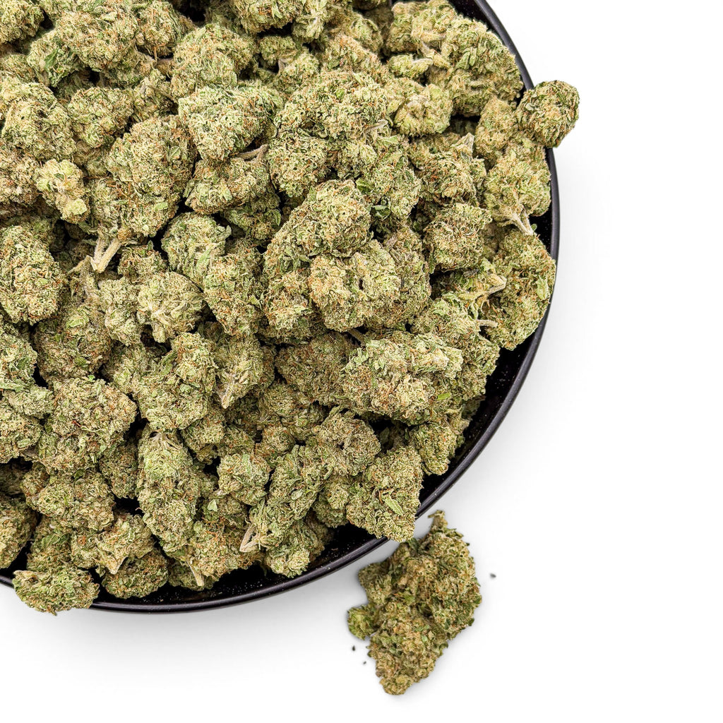 Dr. Wonderstone Lemon Cherry Gelato wholesale Value Indoor THCa flower in a black bowl, featuring vibrant green buds with amber pistils.