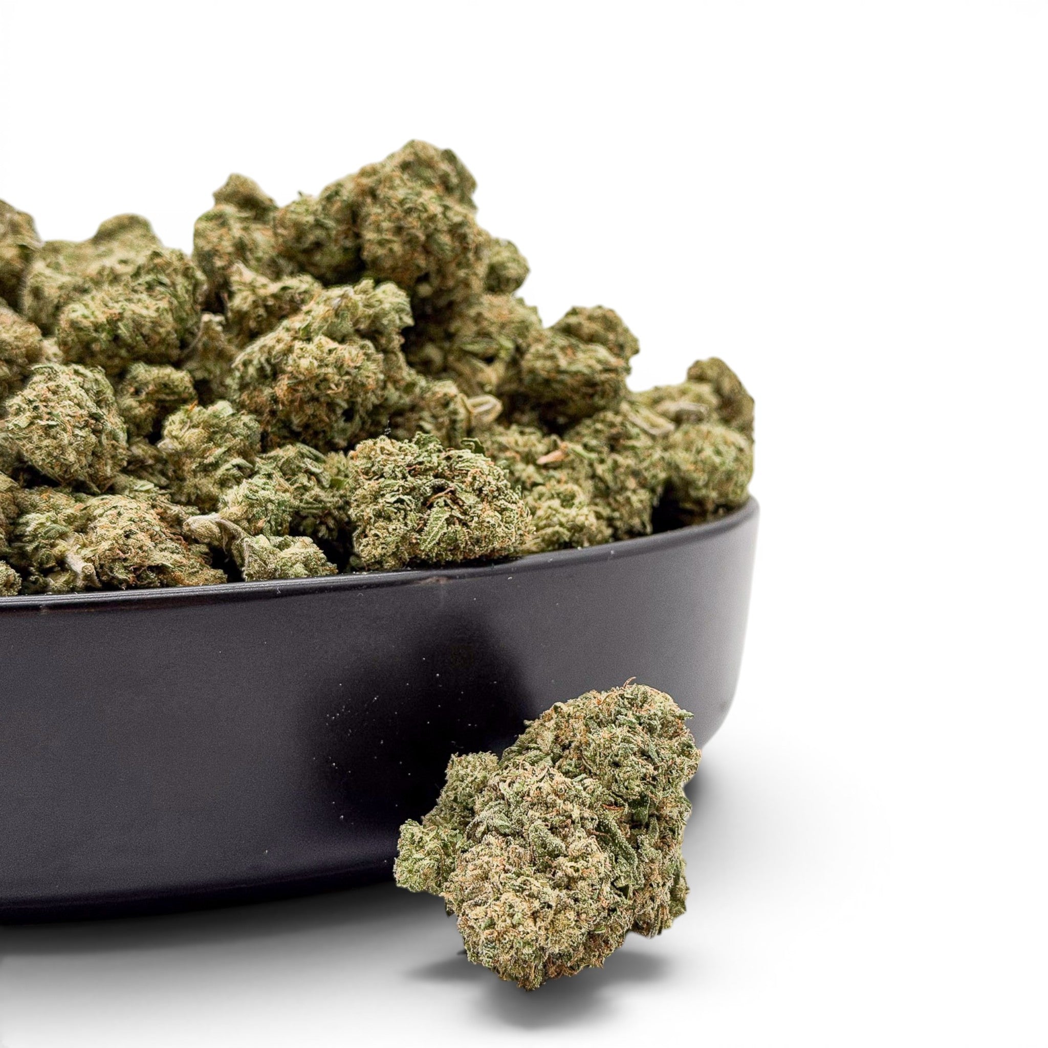Dr. Wonderstone Lemon Cherry Gelato Wholesale Value Indoor THCa flower buds in a black bowl, featuring vibrant green and amber trichomes.