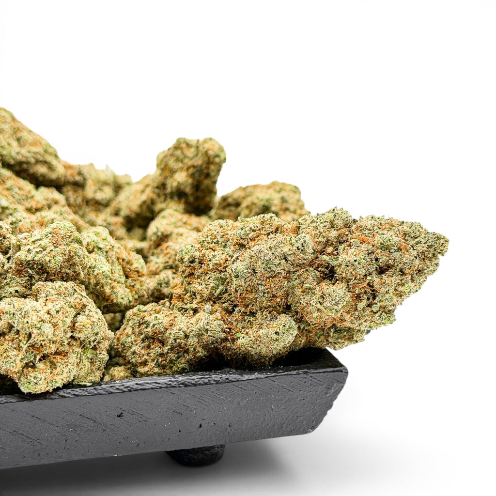 Dr. Wonderstone London Pound Cake THCa flower buds with frosty green texture in a black tray on white background.