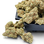 Dr. Wonderstone London Pound Cake THCa flower buds with frosty trichomes and orange pistils on a black tray.