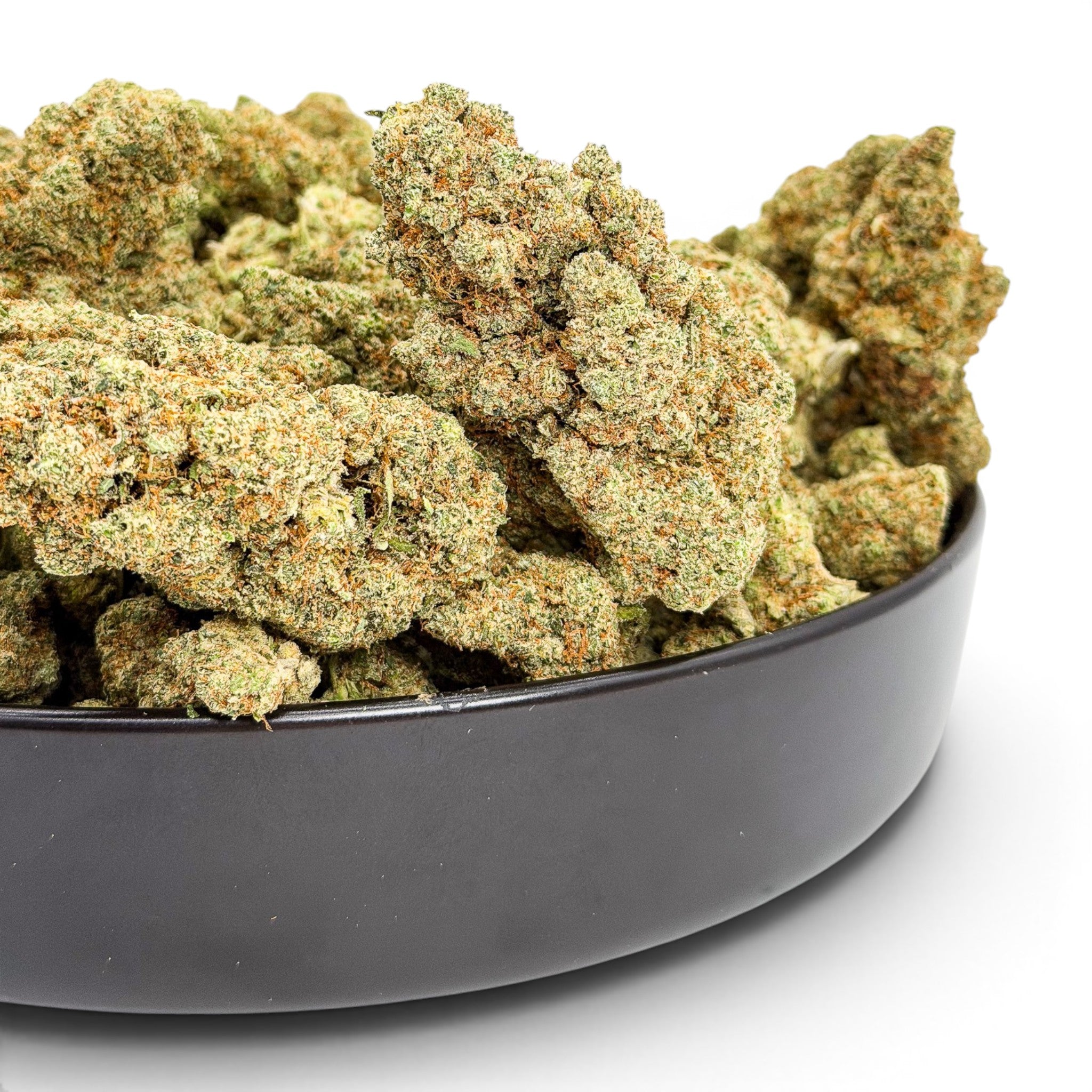 Dr. Wonderstone London Pound Cake THCa flower buds in a black bowl, featuring dense, frosty green and orange nugs.