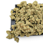 Dr. Wonderstone London Pound Cake THCa flower buds with frosty green texture and orange pistils on a black tray.
