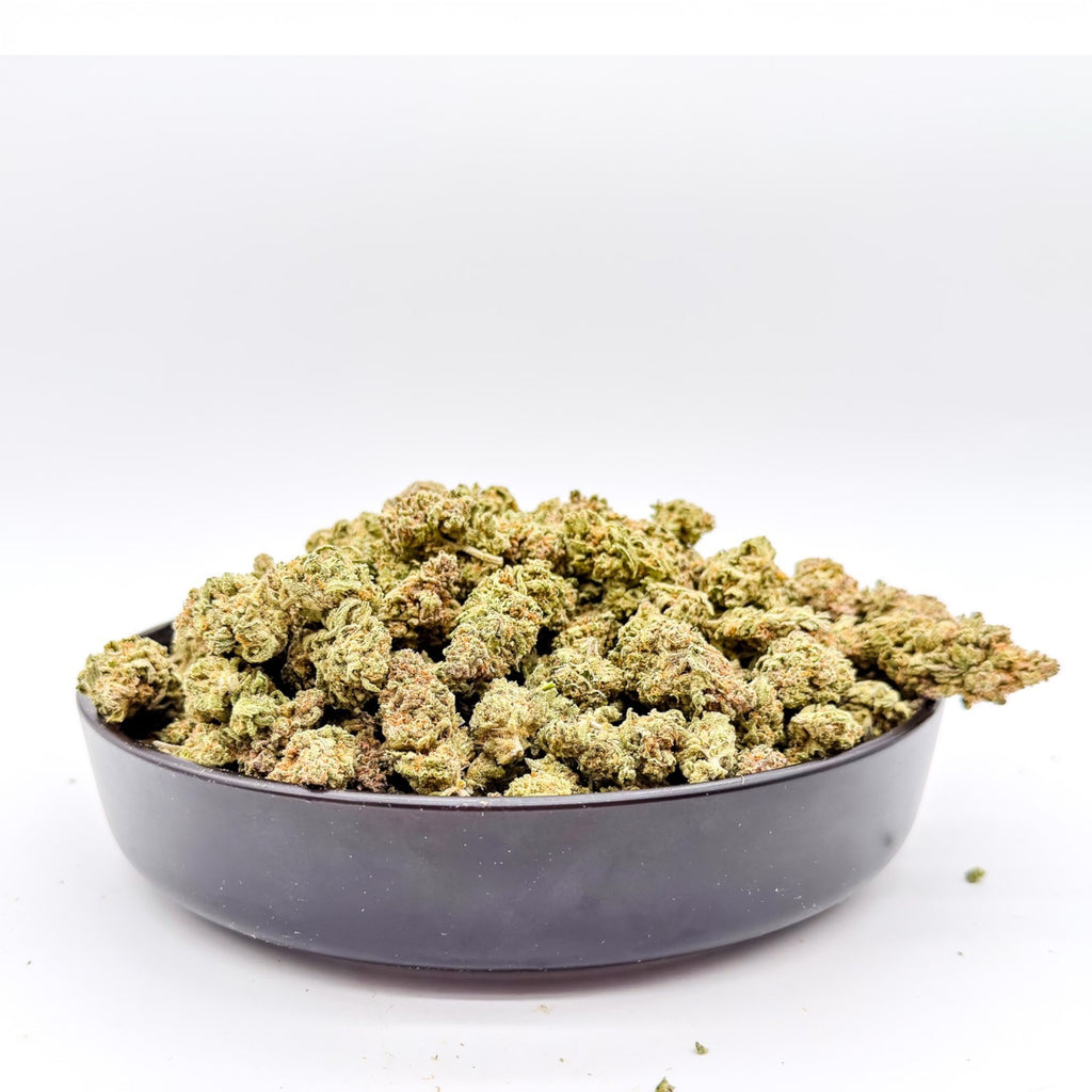Dr. Wonderstone MAC-1 premium THCa flower in a black bowl, featuring frosty, resin-dense green buds.