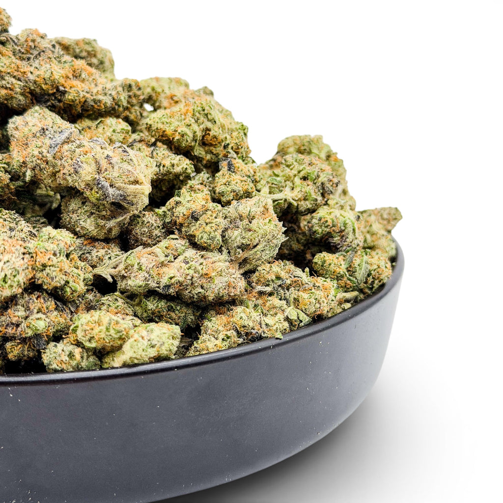 Dr. Wonderstone Northern Lights exotic THCa flower buds with green and purple hues in a black bowl.