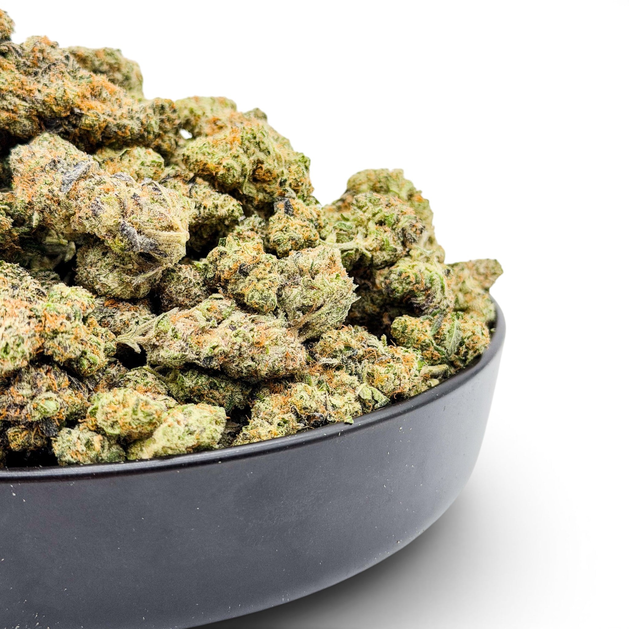 Dr. Wonderstone Northern Lights exotic THCa flower buds with green and purple hues in a black bowl.