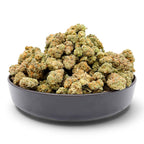 Dr. Wonderstone Orange Blueberry Muffin premium indoor THCa flower buds in a black bowl with orange pistils and trichomes