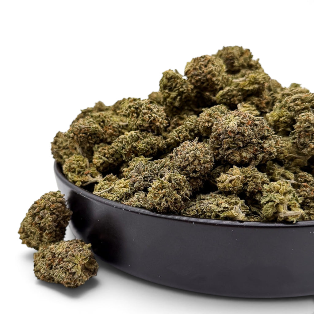 Dr. Wonderstone Oreoz THCa flower in a black bowl, featuring dense, trichome-rich green buds with earthy tones.