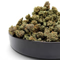 Dr. Wonderstone Pancakes premium THCa flower buds in a black bowl against a white background