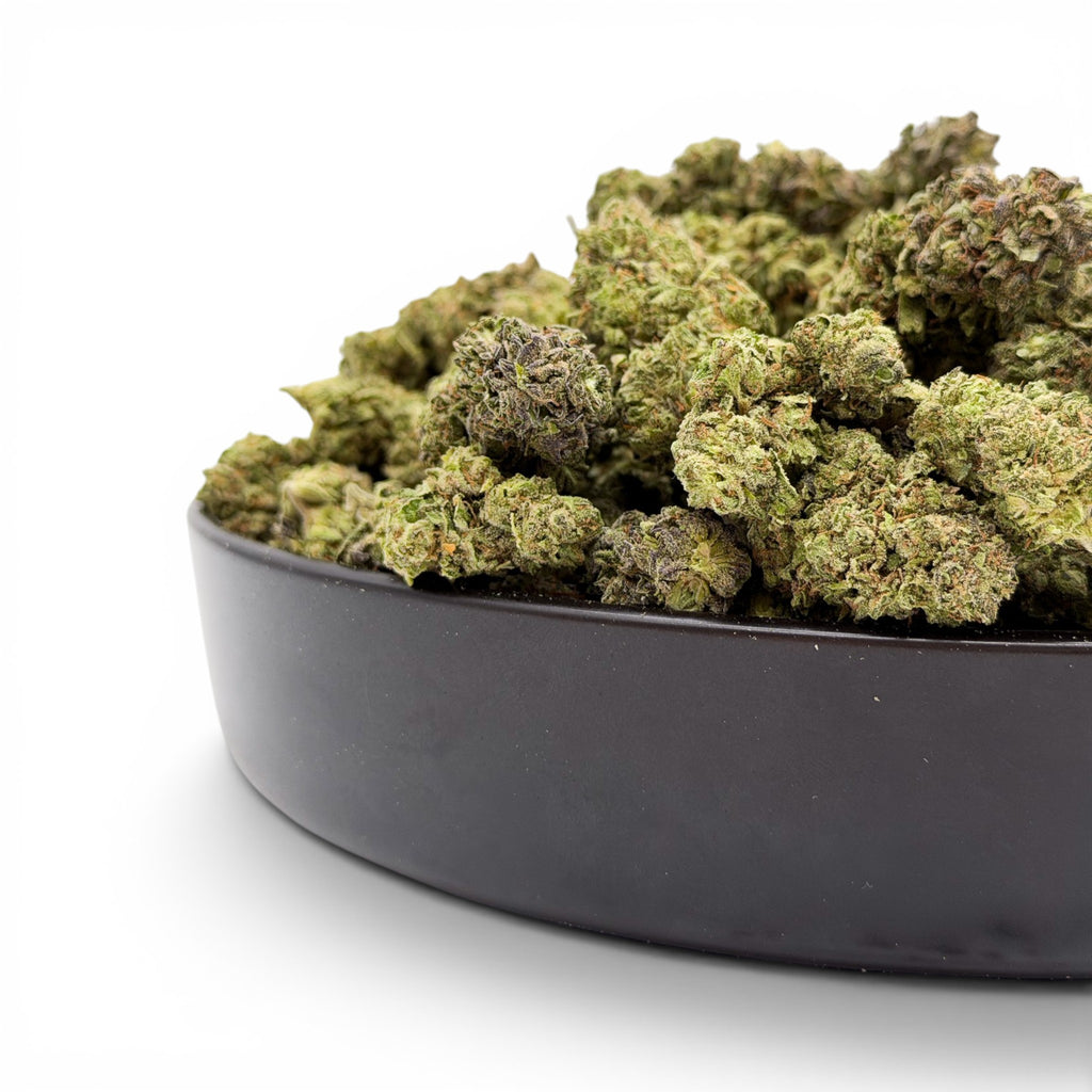 Dr. Wonderstone Pineapple hybrid THCa flower buds with dense green structure and trichome coverage in a black bowl