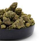 Dr. Wonderstone Pink Kush premium indoor THCa flower buds with dense green structure and orange pistils in a black bowl