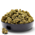 Dr. Wonderstone Purple Rhino exotic THCa flower buds piled in a black bowl against a white background.