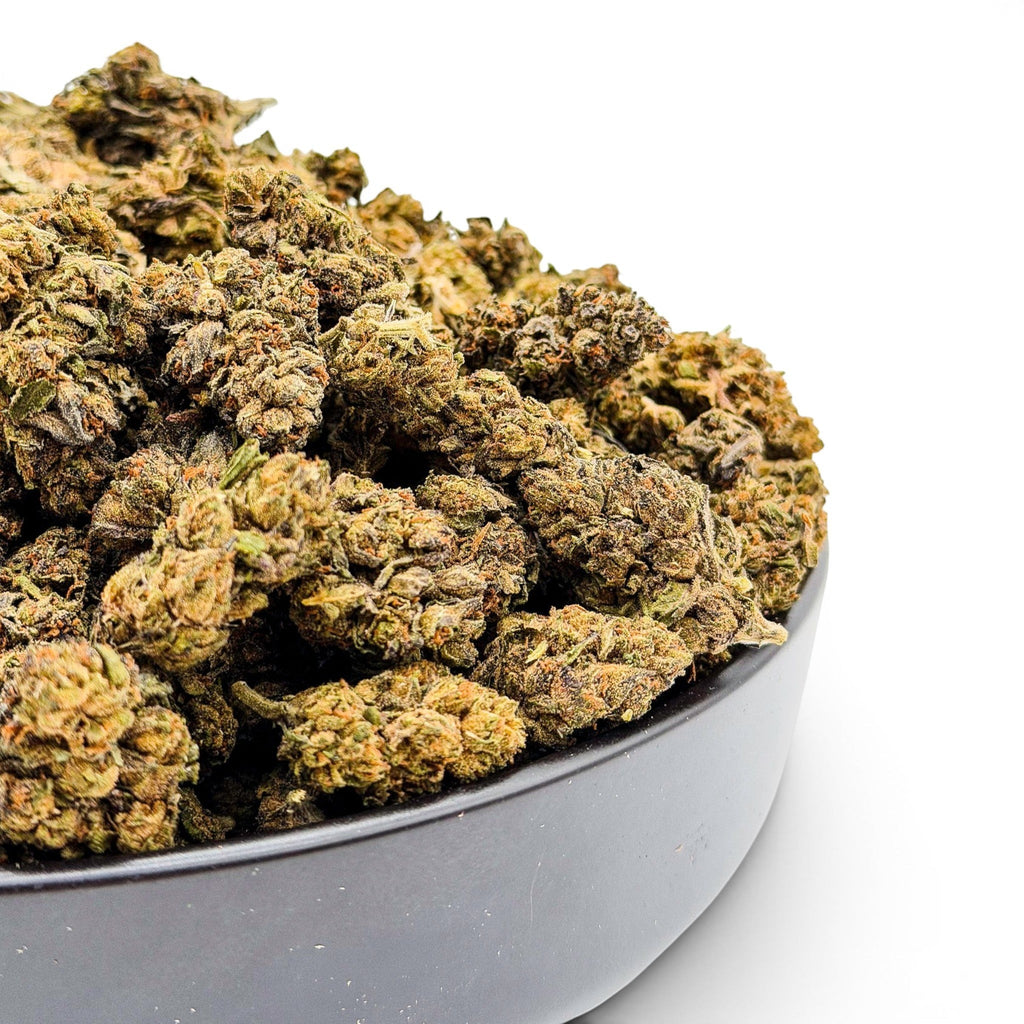 Dr. Wonderstone Runtz premium THCa flower buds in a black bowl, featuring dense green and orange cannabis nugs.