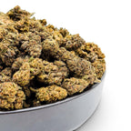 Dr. Wonderstone Runtz premium THCa flower buds in a black bowl, featuring dense green and orange cannabis nugs.