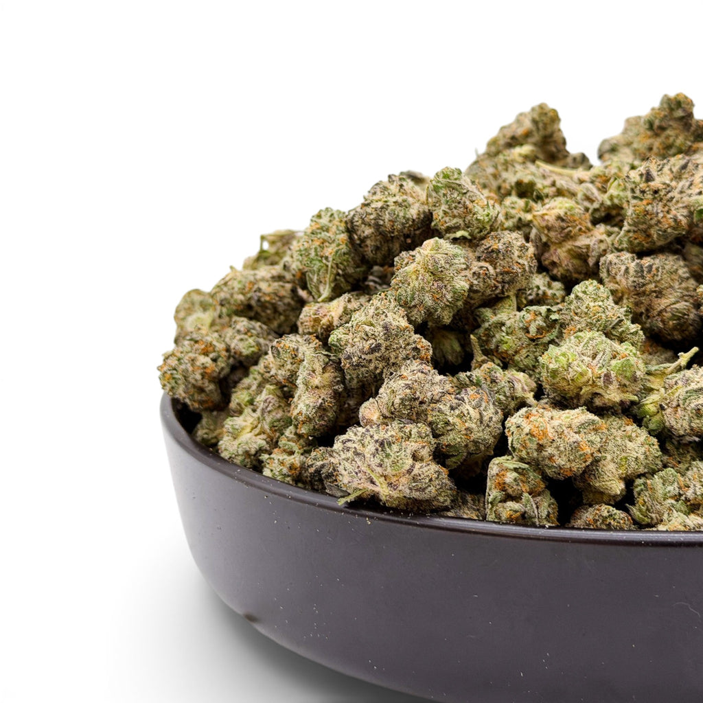 Dr. Wonderstone Secret Cookies THCa flower buds in a black bowl, featuring dense green nugs with orange pistils.