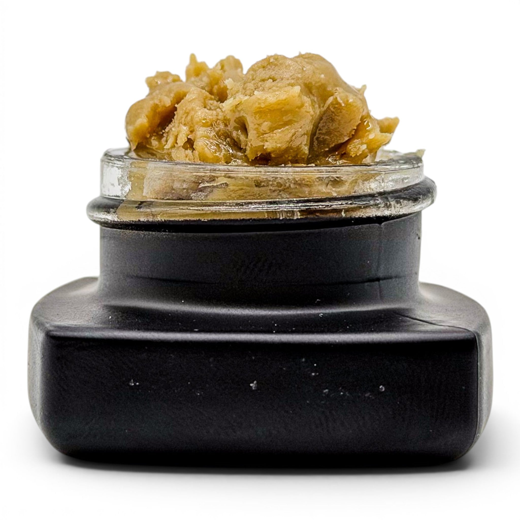 Dr. Wonderstone THCa premium live rosin concentrate in a small black glass jar with a buttery, golden-brown texture.
