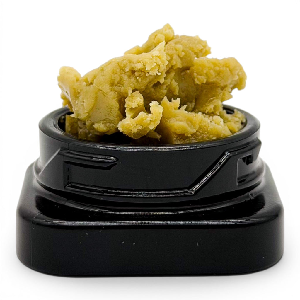 Dr. Wonderstone THCa premium live rosin concentrate with a buttery, golden-green texture in a small black jar.
