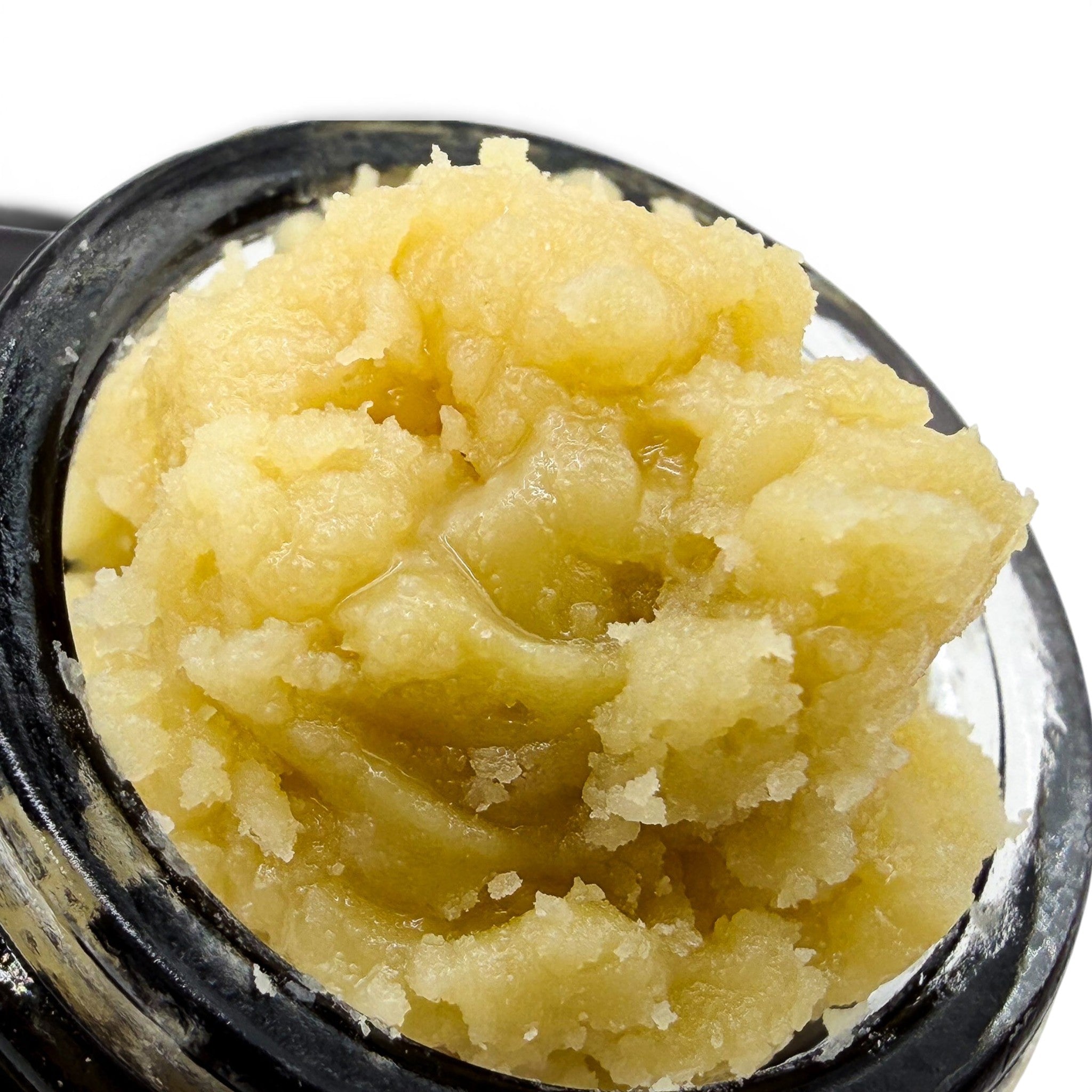 Dr. Wonderstone THCa premium live rosin concentrate with a soft, buttery, golden texture inside a glass jar.