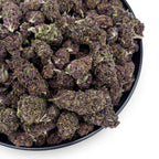 Dr. Wonderstone Tropical Cookies THCa flower featuring dense, dark purple buds with orange pistils in a black bowl.
