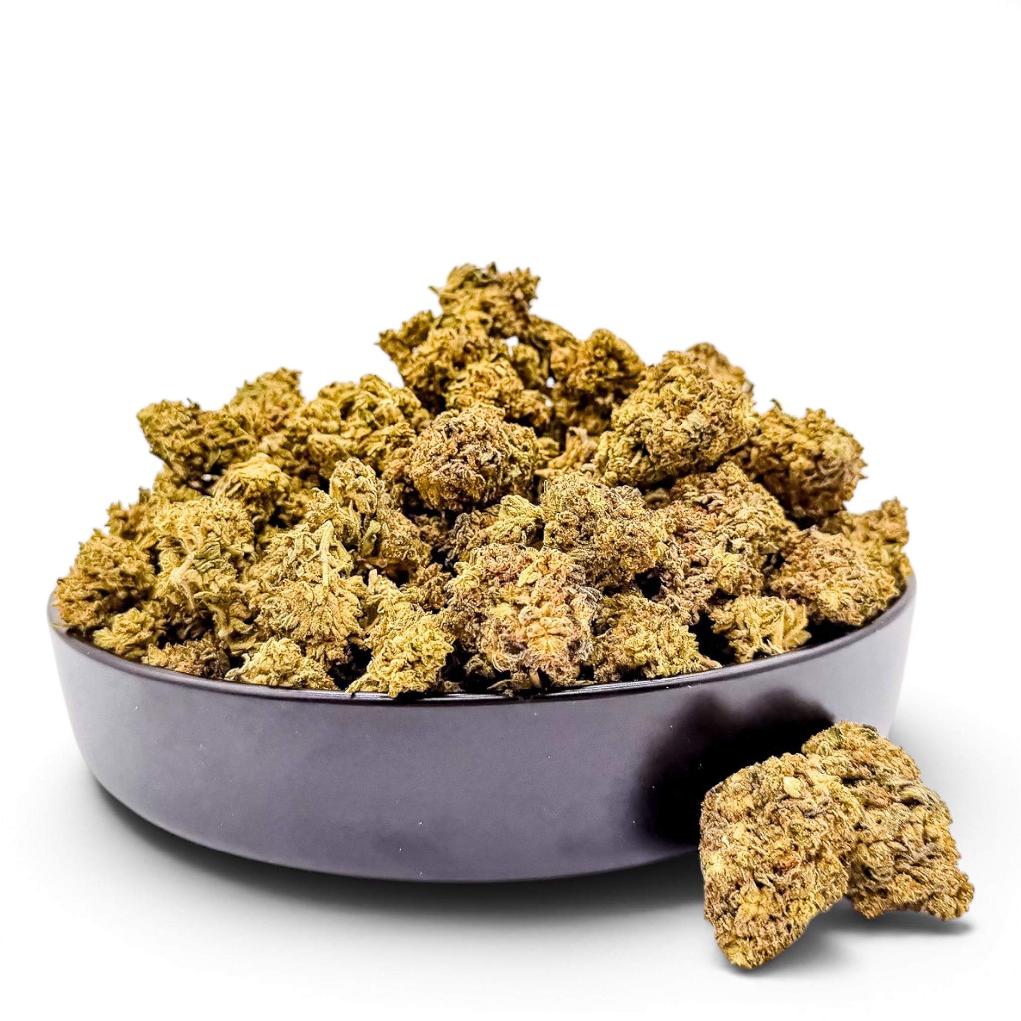 Dr. Wonderstone Wedding Cake THCa flower buds in a black bowl, featuring crystal-dusted green and earthy tones.