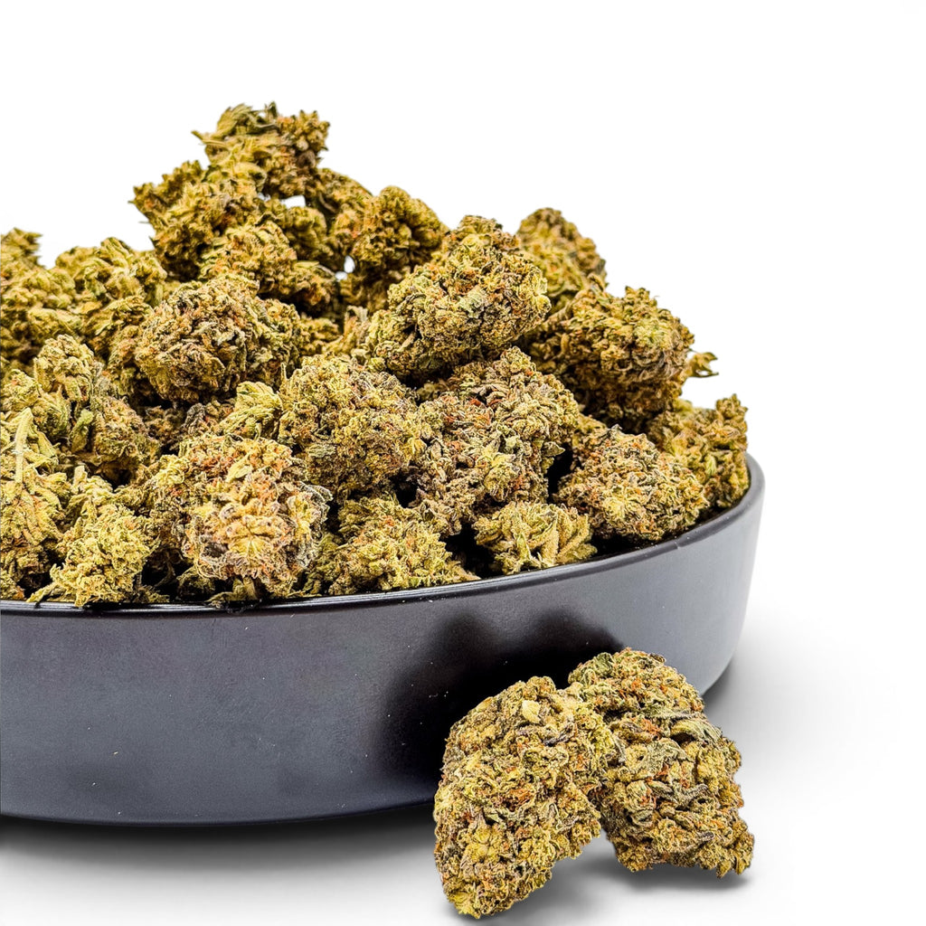 Dr. Wonderstone Wedding Cake THCa flower buds with crystal-dusted green and orange textures in a black bowl.