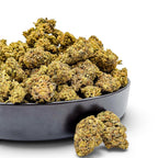Dr. Wonderstone Wedding Cake THCa flower buds with crystal-dusted green and orange textures in a black bowl.